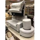 A modern pale grey upholstered corner sofa with pouffe and stool