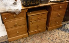 A modern pine knee hole dressing table and three pine bedside chests