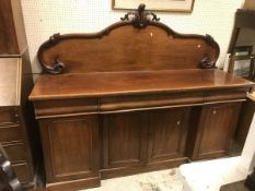 A Victorian mahogany sideboard with raised back over drawers and cupboard door