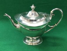 A George V silver urn shaped silver teapot, raised on an oval foot (by Asprey & Co Limited,