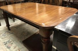 A Victorian mahogany extending dining table with three leaves