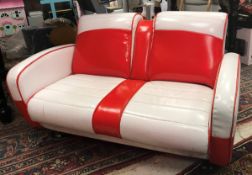 A Fine Line child's simulated red and white leather two seat sofa