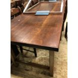 A 19th Century French farmhouse kitchen table with cherrywood top on an oak base with frieze