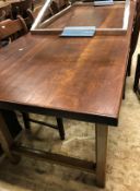 A 19th Century French farmhouse kitchen table with cherrywood top on an oak base with frieze