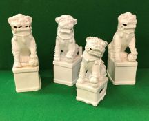 A collection of four 19th Century Chinese blanc-de-chine figues of temple lions, approx 27 cm high,