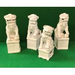 A collection of four 19th Century Chinese blanc-de-chine figues of temple lions, approx 27 cm high,