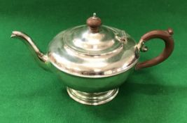 A George V silver squat teapot of circular form,