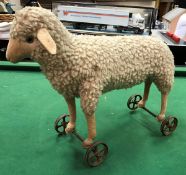 A Steiff wool plush lamb on wheels circa 1920 (button to left ear) CONDITION REPORTS