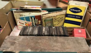 A box of various magic lantern slides, vintage tea cards,