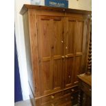 A modern pine two door wardrobe over two short and one long drawer