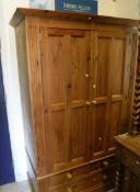 A modern pine two door wardrobe over two short and one long drawer