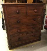 A Victorian mahogany chest of two short over three long drawers raised on a plinth base