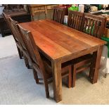 A modern Indian teak dining table and set of eight slat back dining chairs