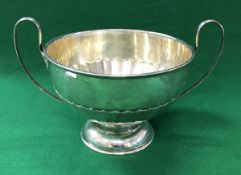 A George V silver trophy cup with reeded handles, the main body semi-fan decorated,