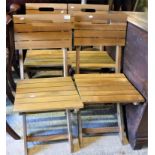 A set of four slatted teak folding garden chairs