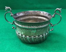 A Victorian silver porringer in the 17th Century style with embossed decoration and dragon head