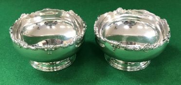 A pair of mid 20th Century silver bowls with cast scrolling foliate decorated rims,