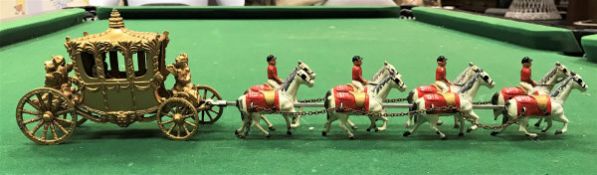A die cast model of the Royal coach and eight together with Elizabeth II Coronation medal,