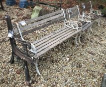 An early 20th Century wrought iron and slatted wooden three piece garden suite,