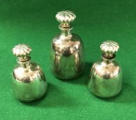 A set of three Asprey silver mallet shaped bottles with squash form stoppers (London 1981), 15.