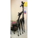 A pair of polished steel figures of giraffe and calf