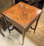 An Edwardian rosewood and inlaid envelope card table the base united by an under tier