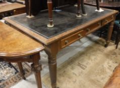 A 19th Century mahogany library table with tooled leather writing surface over three frieze drawers