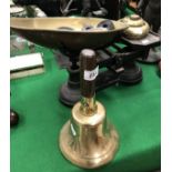 A brass hand bell,