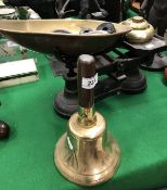 A brass hand bell,