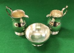 Two silver baluster shaped cream jugs (by Roberts & Belk, Sheffield 1982 and 1984),