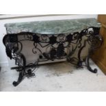 A wrought iron console table in the Rococo style black painted with green marble top