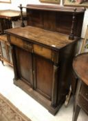 A Regency rosewood chiffonier with shelved superstructure over two drawers and two cupboard doors