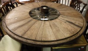 A hand made oak centre table constructed from wooden cartwheel with central nut inscribed "CH.