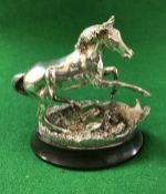 A cast silver model of a horse "Startled Yearling" by Geoffrey Snell,