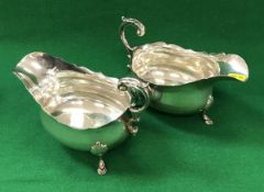 A pair of Edwardian silver sauceboats of inverted helmet form,