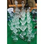 A collection of glassware to include a Robert Welsh hurricane lamp, two cut glass decanters,