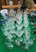 A collection of glassware to include a Robert Welsh hurricane lamp, two cut glass decanters,