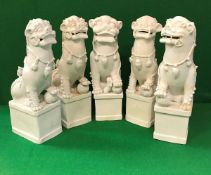 Five 19th Century Chinese blanc-de-chine figures of temple lions, approx 34 cm high,