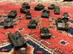 A box containing various Dinky military vehicles including armoured command vehicle 677,