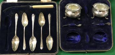 A pair of silver cauldron open salts with plain glass liners and two spoons and a set of five