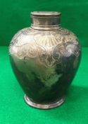 A George II silver tea caddy of Chinese form with scrolling foliate and shell decorated shoulders,