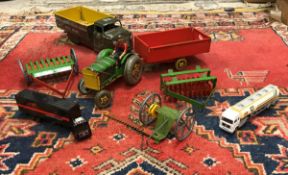 A Mettoy Playthings tractor and accessories including trailer, rake, disc harrow etc,