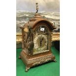An early 20th century oak cased mantle clock with gilt brass embellishments,
