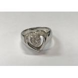 An 18 carat white gold and diamond set cross over love heart ring, 5.