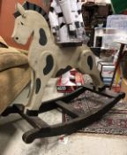 A vintage dapple painted rocking horse of small proportions