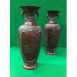 A pair of 19th Century Japanese chocolate patinated bronze vases with relief work decoration of