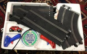 Two boxes containing Scalextric track and two race car vehicles and control units