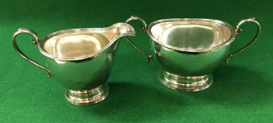 A pair of George V silver cream jug and sugar bowl with reeded edge,