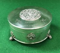 A George V silver cylindrical dressing table box with Celtic style medallion decoration to the top,