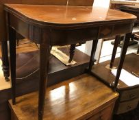 A 19th Century mahogany and inlaid fold over card table on square tapered legs together with a late